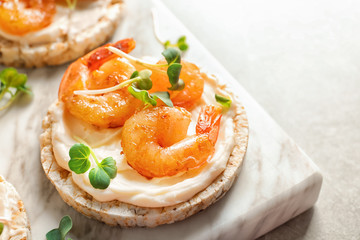 Delicious small sandwich with shrimps on marble board, closeup