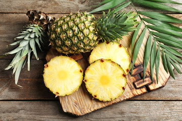 Fresh pineapple on wooden board - obrazy, fototapety, plakaty