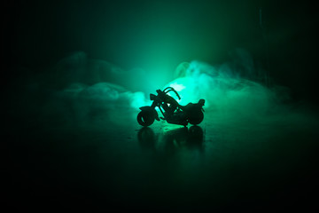 High power motorcycle chopper. Fog with backlights on background with man rider at night. Empty space
