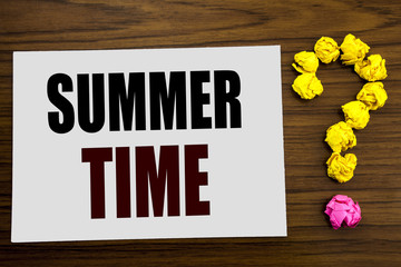 Fototapeta premium Hand writing text caption inspiration showing Summer Time. Business concept for Holiday Travel Welcome written on white note paper on the wooden background with question mark on the end.