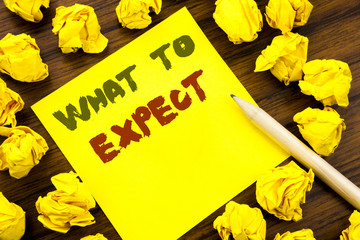 Fototapeta premium Word, writing What To Expect. Business concept for Achieve Expectation Written on sticky note paper, wooden background with folded yellow paper meaning thinking