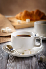 Obraz na płótnie Canvas Black coffee and croissants.