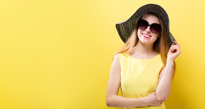 Happy young woman wearing a summer hat