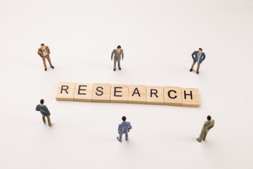businessman figures meeting on research word