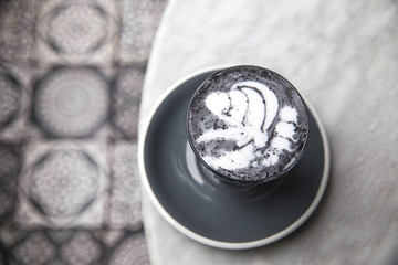 Charcoal super latte on marble background.