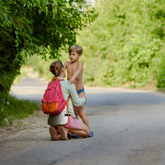 Young boy with his mother speaking together on weekend. square aspect ratio