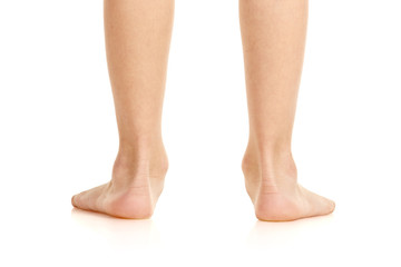 Closeup of little male flatfoot legs isolated on white background - obrazy, fototapety, plakaty
