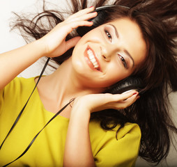 Fototapeta premium Woman with headphones listening music. Music girl dancing against white background.