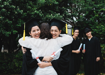 A graduate hugging her mother.