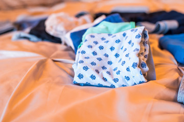 folded women's underwear on bed 