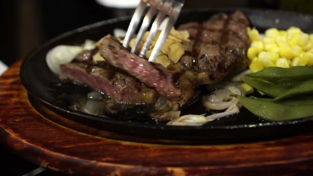 Beef Steak Premium beef steak in sizzling pan with corns and peas side dish 4k video