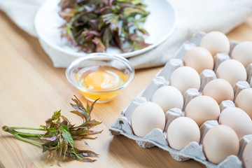 Chinese food, Scrambled Eggs with Toona sinensis,  Preparing food. Fresh Toona sinensis and eggs on table.