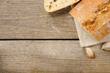 Ciabatta bread. Slices of ciabatta on wooden table on linen cloth. Rustic style, italian. Top view, background