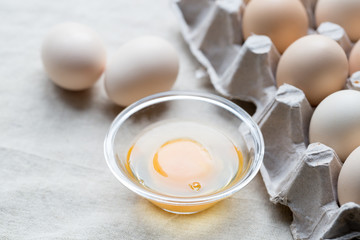 Fresh farm eggs. Egg yolk in glass bowl.