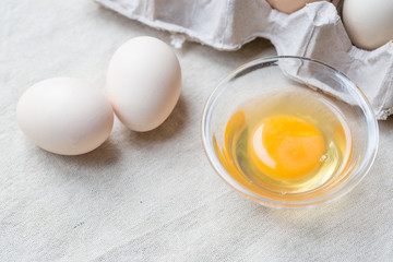 Fresh farm eggs. Egg yolk in glass bowl.