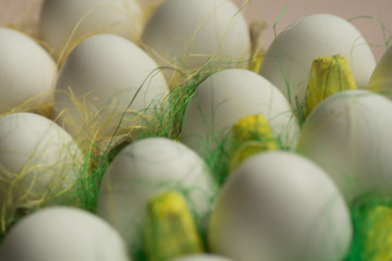 Chicken eggs in colored paper eco-friendly packaging with decorative sisal. Close-up photo, macro. Easter background Food concept 