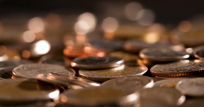 Close up money the coin stacking on  the floor in dark light , business and financial for money saving or investment background concept  , extremely close up and shallow DOF