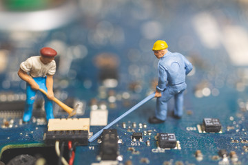 Miniature people : Worker team of engineers repairing keyboard computer laptop
