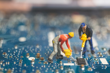 Miniature people : Worker team of engineers repairing keyboard computer laptop