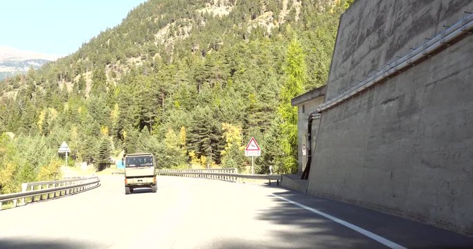 Driving in the alps, Cinema 4k pov view driving on a route between swiss alps towards Brig city, on route e62, on a sunny autumn day, down from the Simplon pass, in Valais, Switzerland