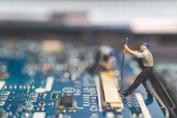 Miniature people : Worker team of engineers repairing keyboard computer laptop