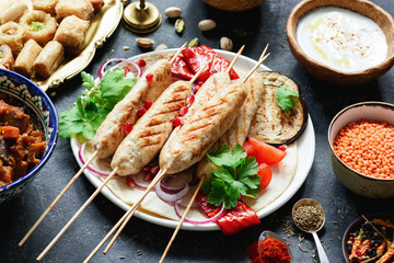 Shish kebab, meat skewers or shashlik garnished with parsley, pomegranate seeds and grilled...