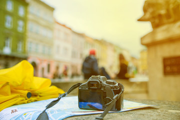 travel concept. camera on the map with blurred town on background