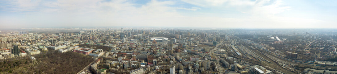 Fototapeta premium Panoramic photo of the city of Kiev with the stadium Olympic against the blue sky.