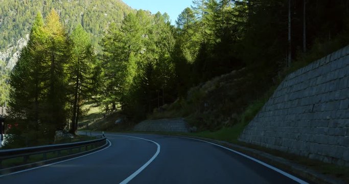 Driving on a mountain road, Cinema 4k pov view driving on a route between swiss alps, on route e62, on a sunny autumn day, down from the Simplon pass, in Valais, Switzerland