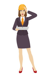 Businesswoman in construction helmet holding a digital tablet PC and grabbed his head