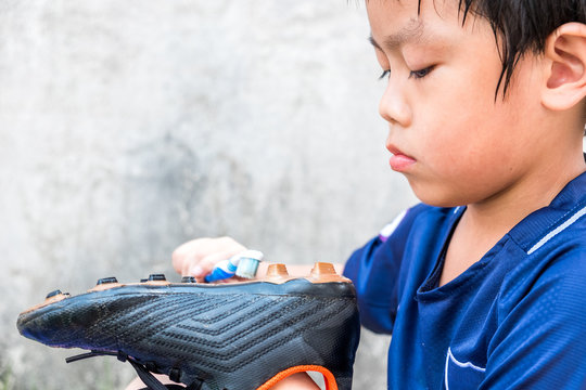 A boy is cleaning his stud after the match. He understand this is his responsibility