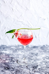 Red cocktail with flowers. Nikerboker.Rom with cranberries
