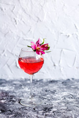 Red cocktail with flowers. Nikerboker.Rom with cranberries