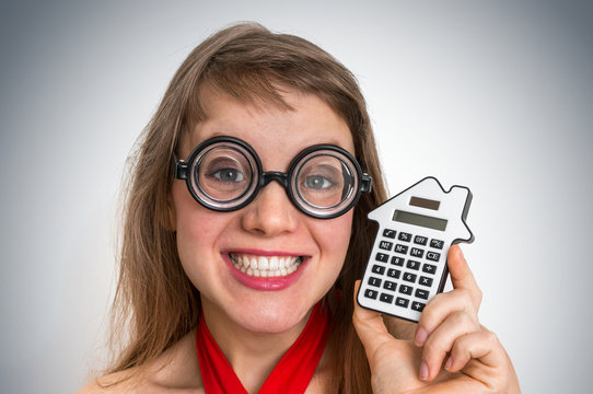 Funny geek or nerd school woman with calculator in her hand