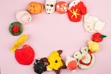 Children's crafts from salted dough - different animals, heart, flowers painted with colors, copy space