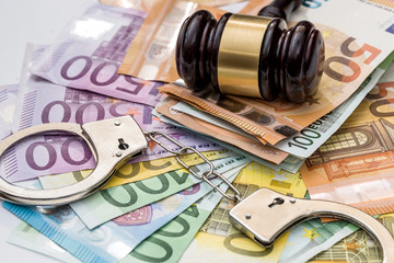 Justice, bribery and punishment. Euro with handcuffs and gavel