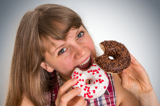 Attractive woman is eating a delicious donuts