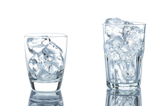 Empty glass with ice cubes on white background