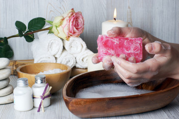 A piece of soap in a woman, the process of washing hands before spa procedures for the skin of hands