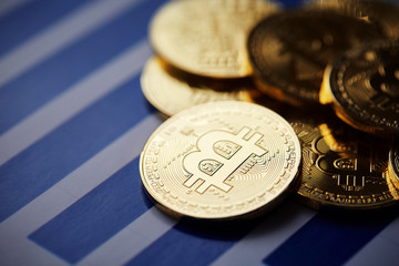 Bitcoin cryptocurrency on the chart background, close-up, shallow depth of field