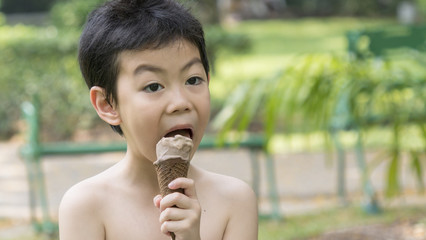 kid boy eat ice cream in close up face feeling delicious