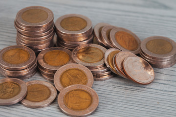 Stacking money coins on wood background, the saving with growing up your money.