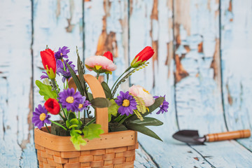 flowers in bamboo basket on wood background