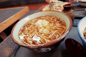 Kake Soba, close up Japanese cusine, hot soba noodles topped with  japanese bunching onion in japanese restaurant.