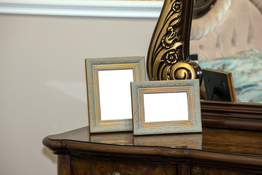 Two blank photo frame on the chest of drawers. Mock up of blank photo frames