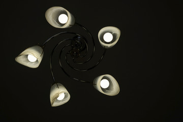 Chandelier with light bulbs on a black background