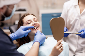 Patient's teeth shade with samples for bleaching treatment.