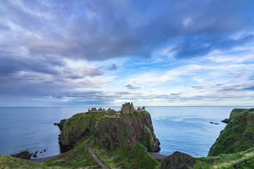 Naklejka premium Sunset seascape at Dunnottar Castle, Stonehaven, Aberdeenshire, Scotland, Britain