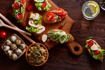 Breakfast still life with sandwiches, quail eggs, spicies and fresh fruits and vegetables, selective focus