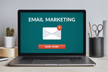 Email marketing concept on laptop screen on modern desk. All screen content is designed by me. Front view. © maicasaa